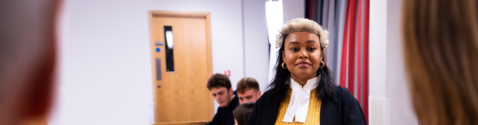 Student in full gown and wig.