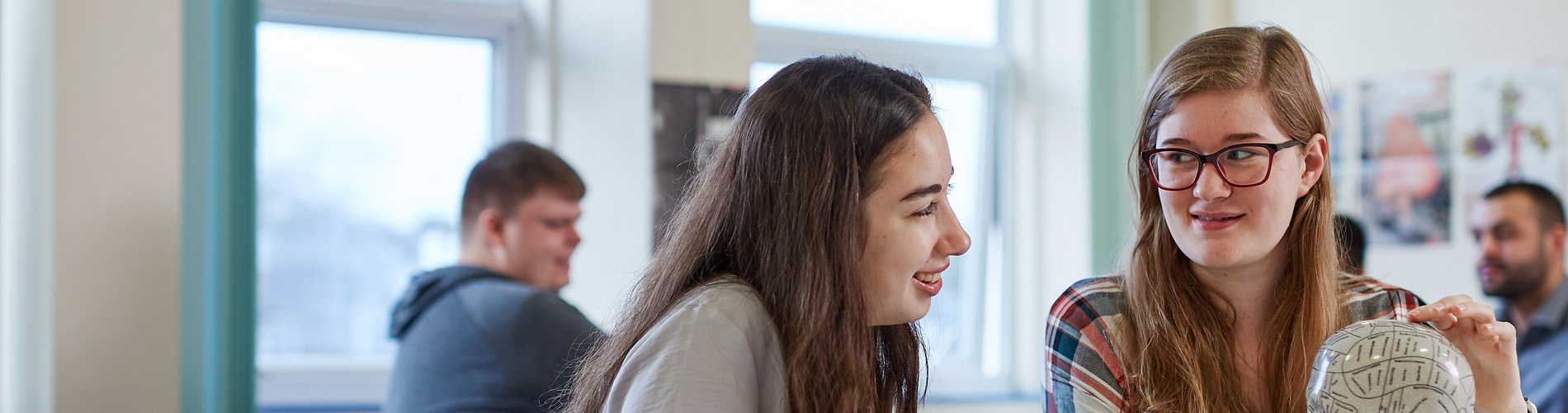 students working with a brain prop.