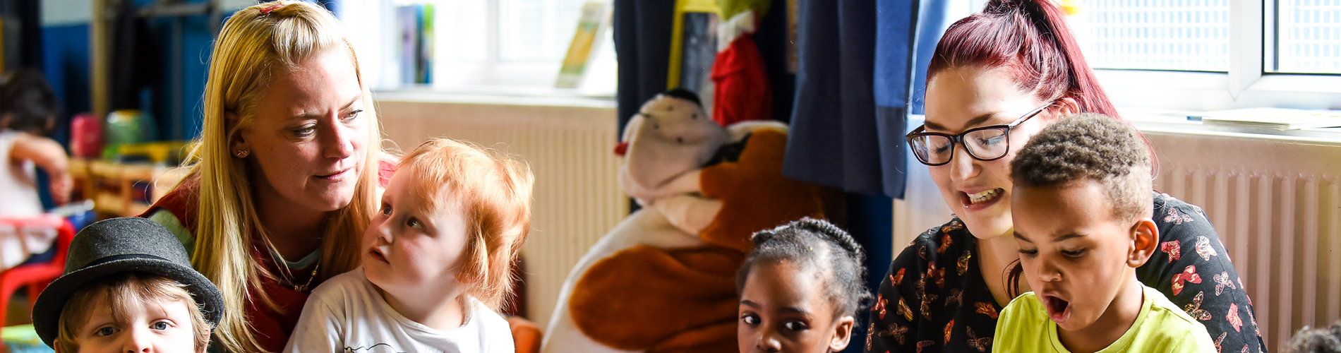 Adults and pupils in an early years setting.