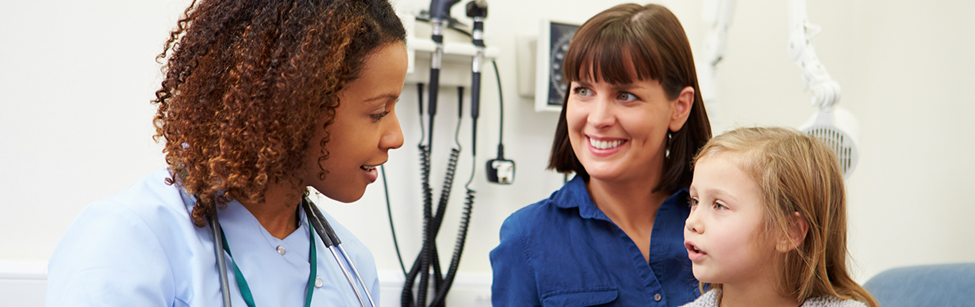 nurse talking to child and parent.