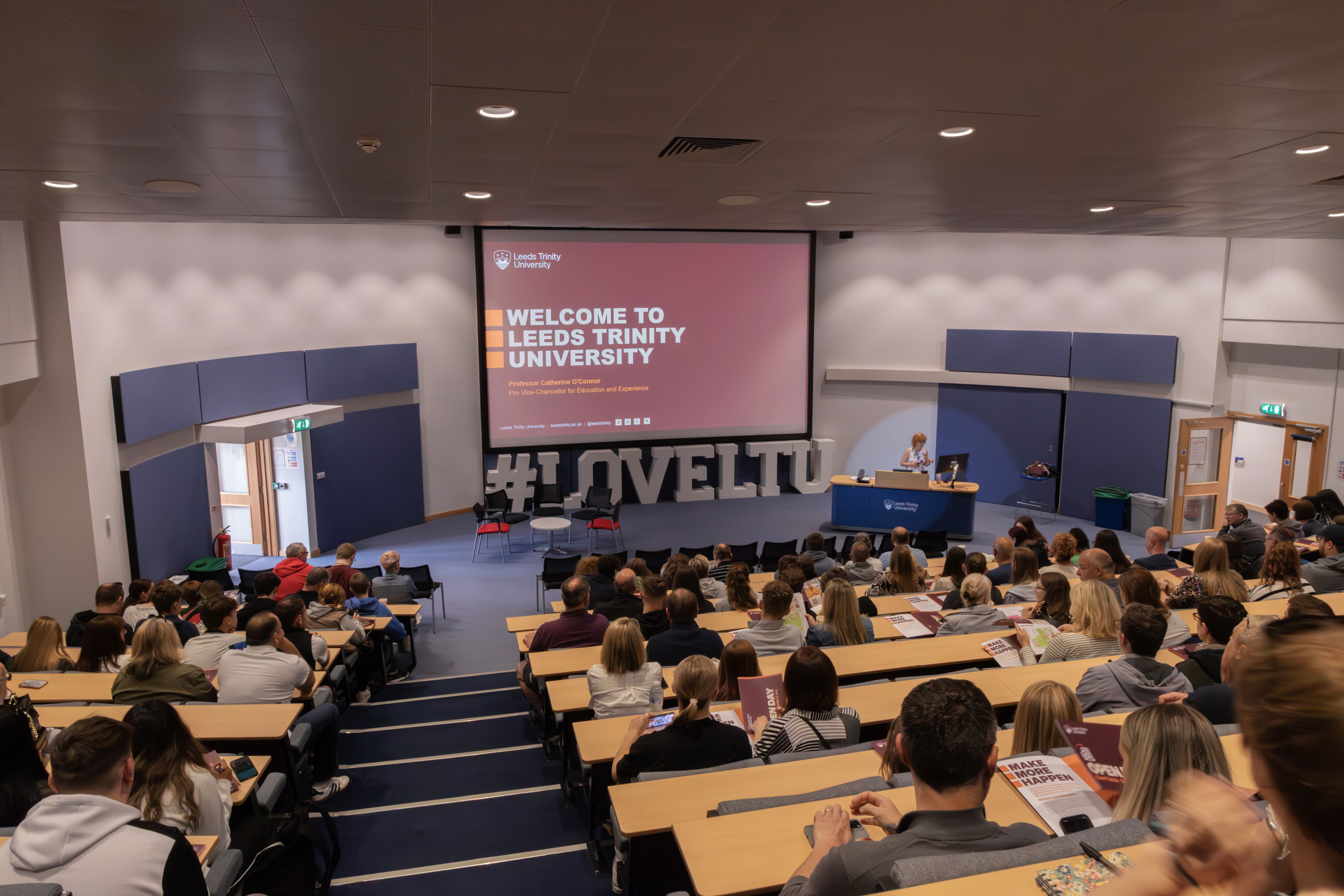 A lecturer is delivering the welcome talk at an Open Day.