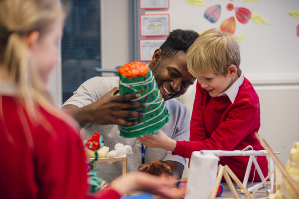 Teacher playing with a toy with a student.