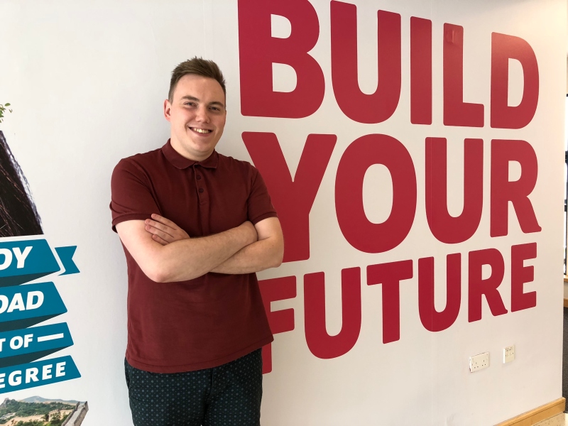 Joe Burrows next to Build Your Future sign.