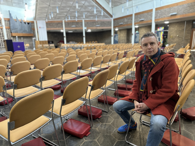 Christopher Banham sitting in chapel.