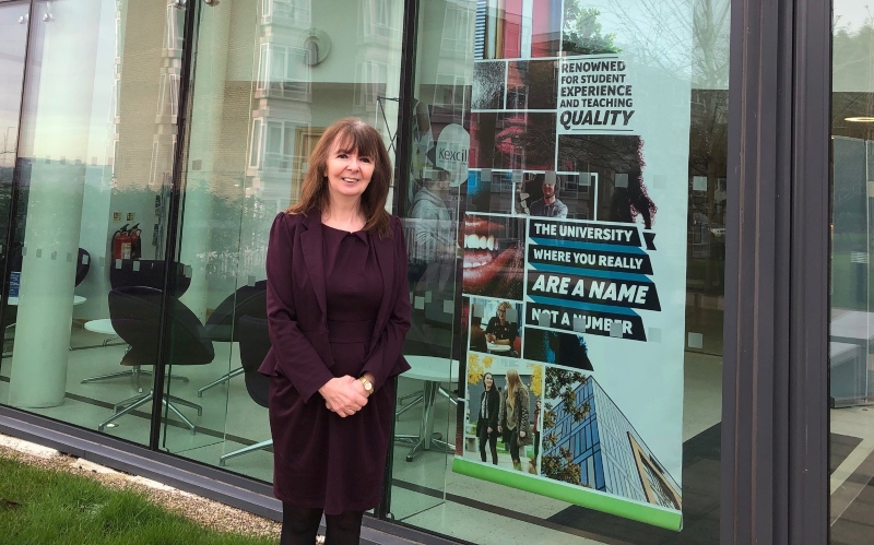 Christine Wilson outside main building.