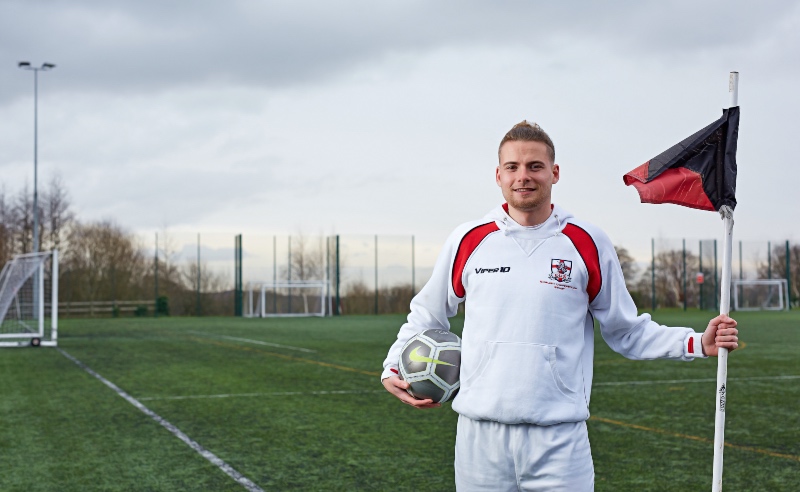 Matthew Broadley on the astroturf pitch posing .