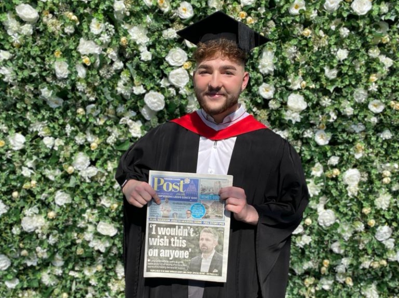 Tom Allen at grad with paper.