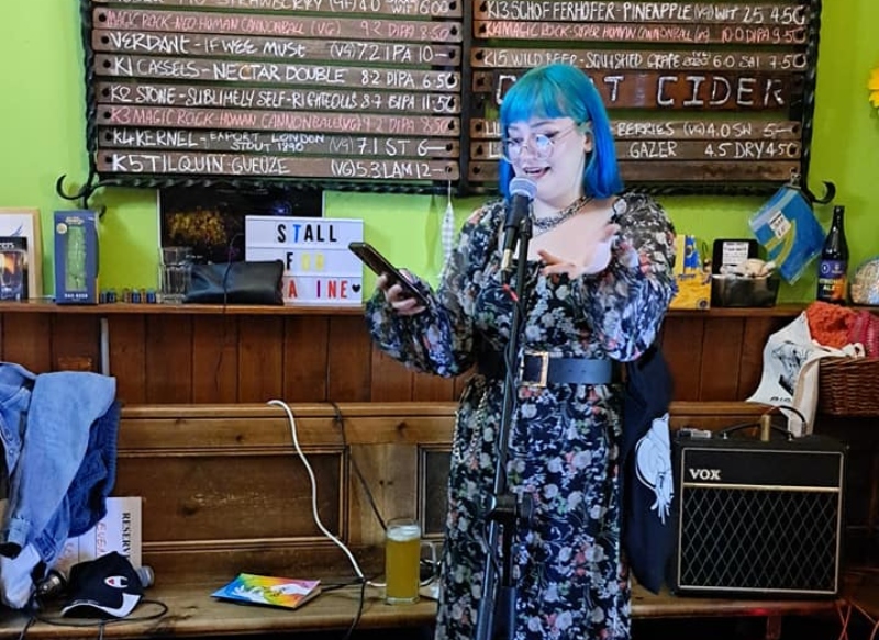 Caitlin McKenna reading at event.