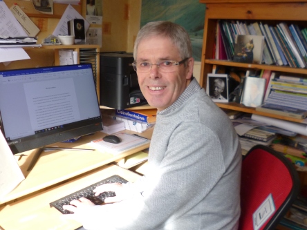 John Irving Clarke sitting at the computer 