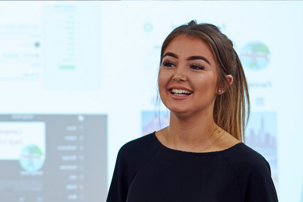 Woman standing in front of a presentation.