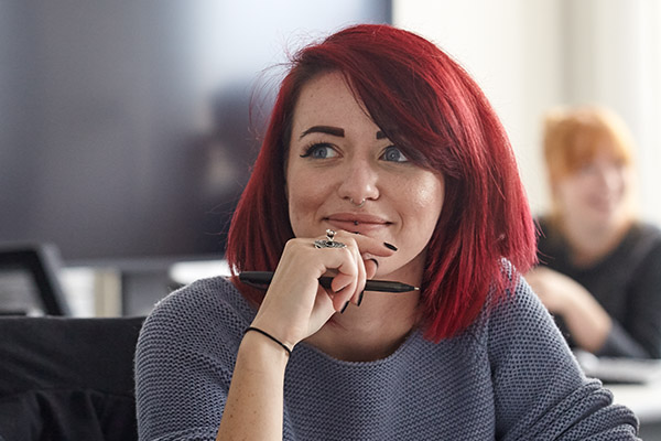 A female student listening in a lecture.