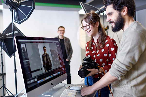 Student being taught how to use photography studio .