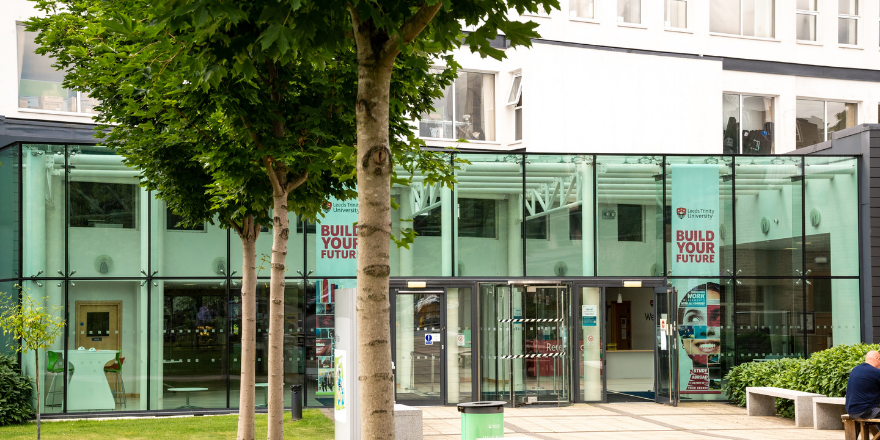 Leeds Trinity University entrance with tree in foreground.