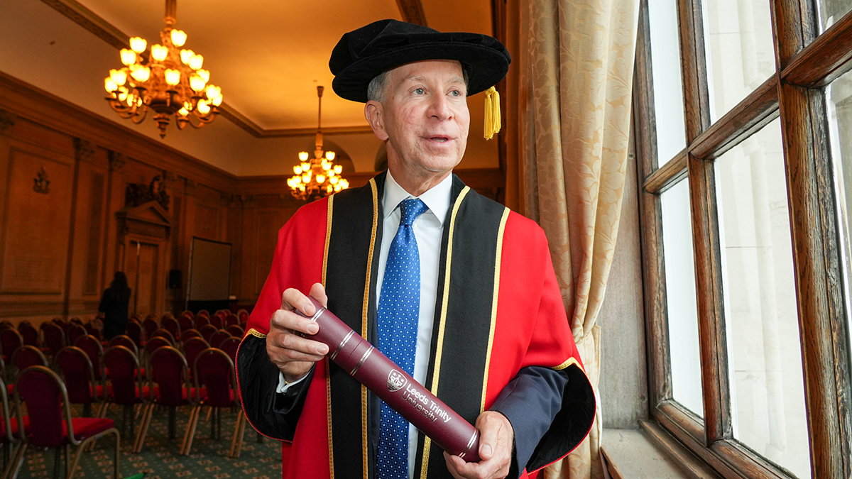 The Chancellor of Leeds Trinity University in official gown, holding his installation scroll..