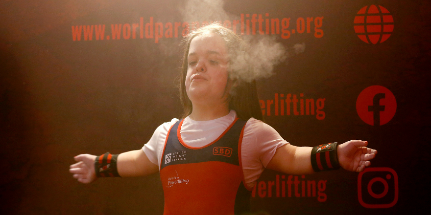 Female student competing in weightlifting at Para Championships.