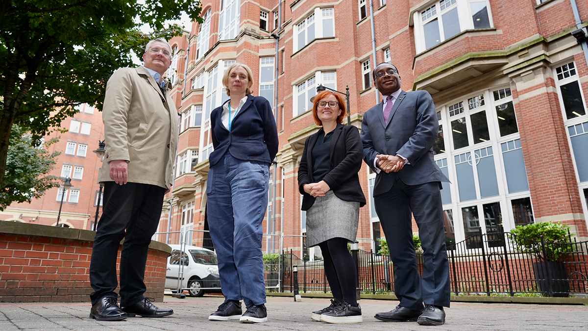 Four people outside the Leeds Trinity University City Campus..