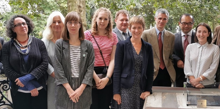 A group shot of researchers next to a table.