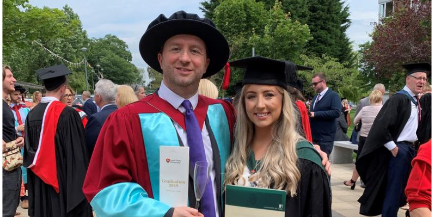 Lecturer and student celebrating graduation.