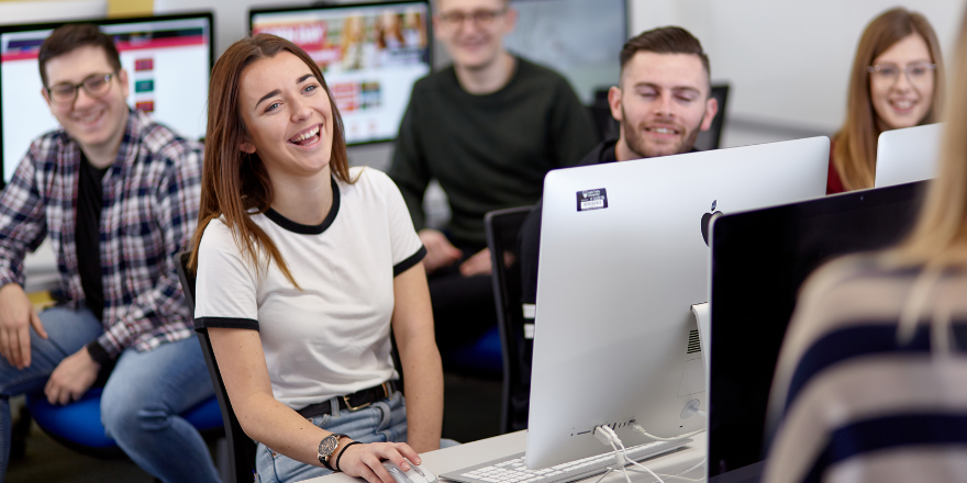 Students sat at computer.