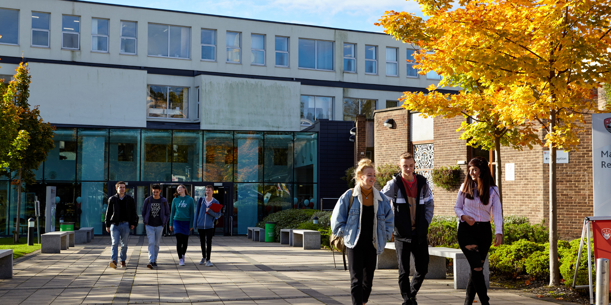 Students walking around university building.