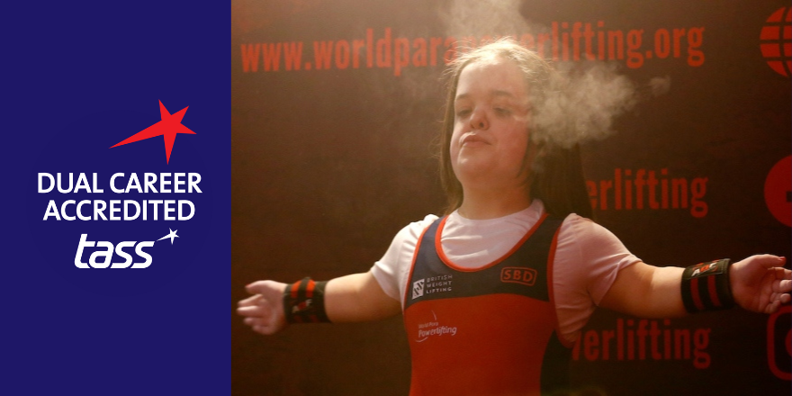 Split screen shows TASS blue logo on left and female powerlifter Charlotte McGuinness in action on right.