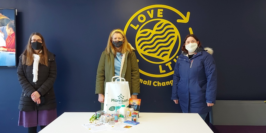 Three women in masks with package.