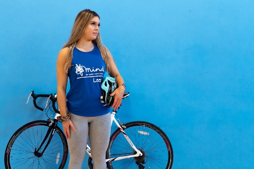 Rose Baldwin landscape photo with bike and helmet under arm .