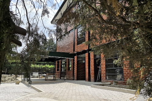 Brick building with trees .