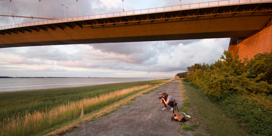 Photographer shooting from the banks of the river .