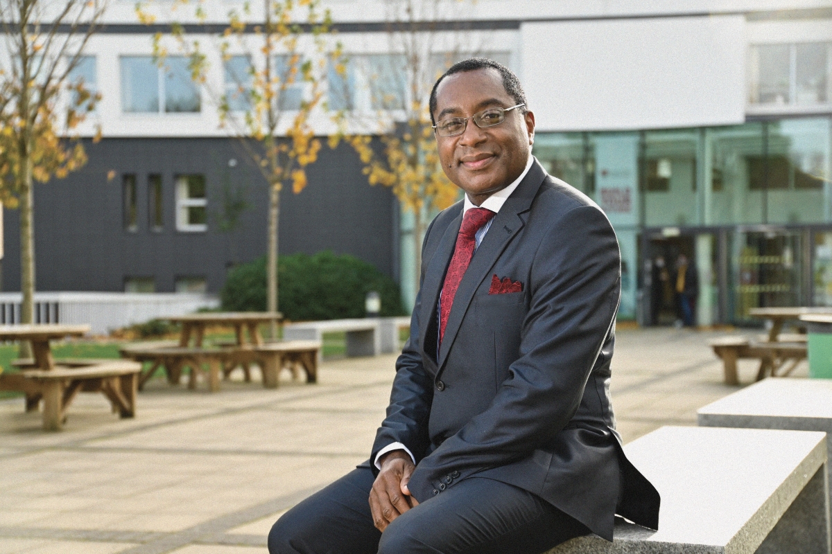 Leeds Trinity University Vice Chancellor sat on a bench outside Main Campus..