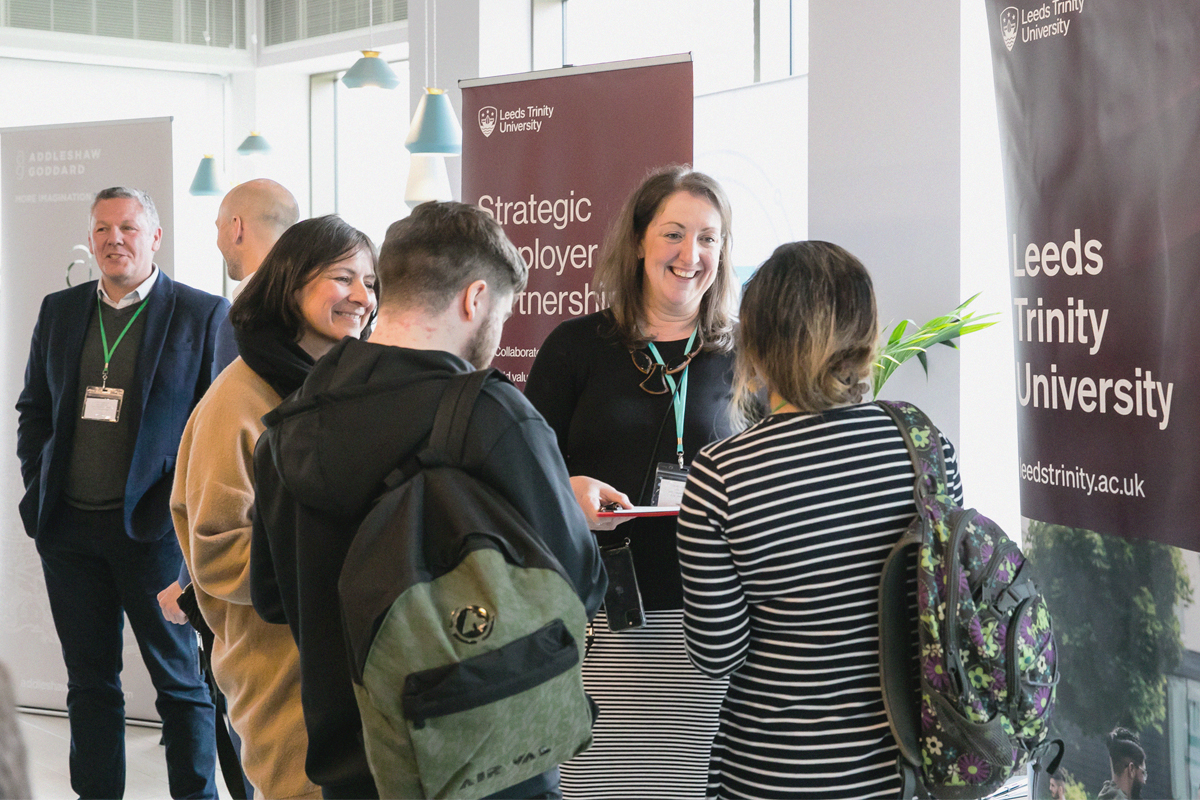 Employer Partnerships team speaking with visitors at an event..