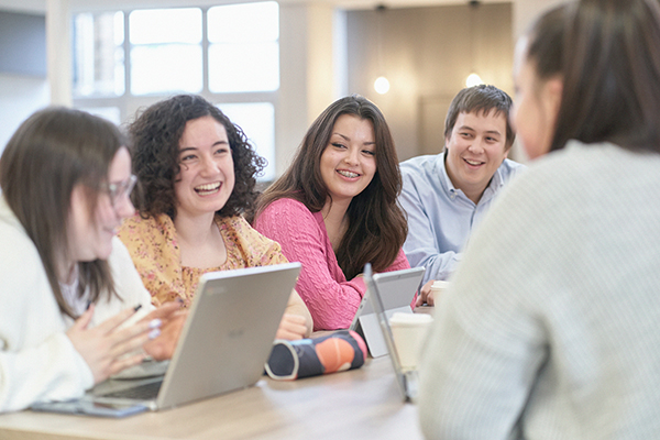 Group of students studying in dining hall.