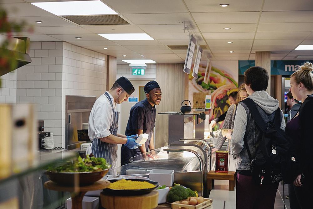 Students queue up for food in the dining room on Main Campus.