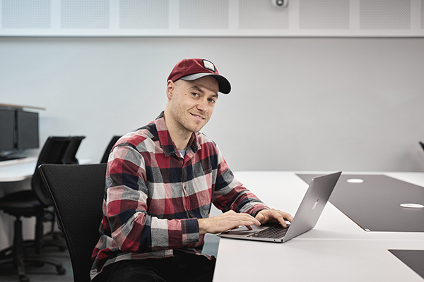 Postgraduate student studying with laptop.