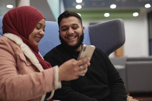 Two students using phone.