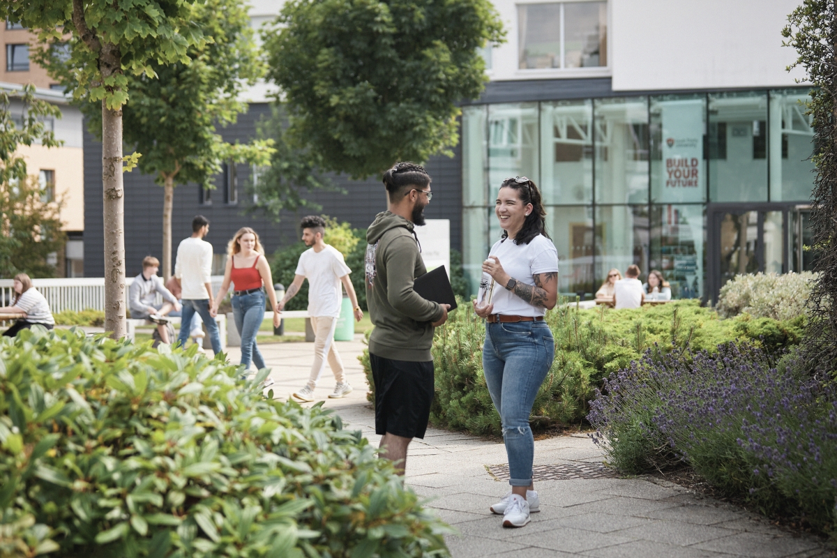 Students talking outside AKLC and Main Campus Reception entrances..