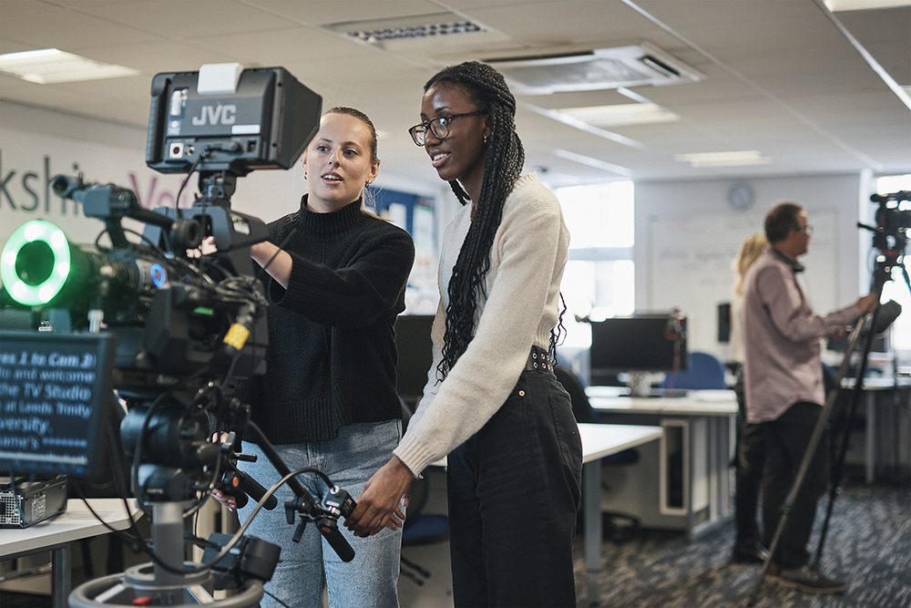 Two media students working with a camera.