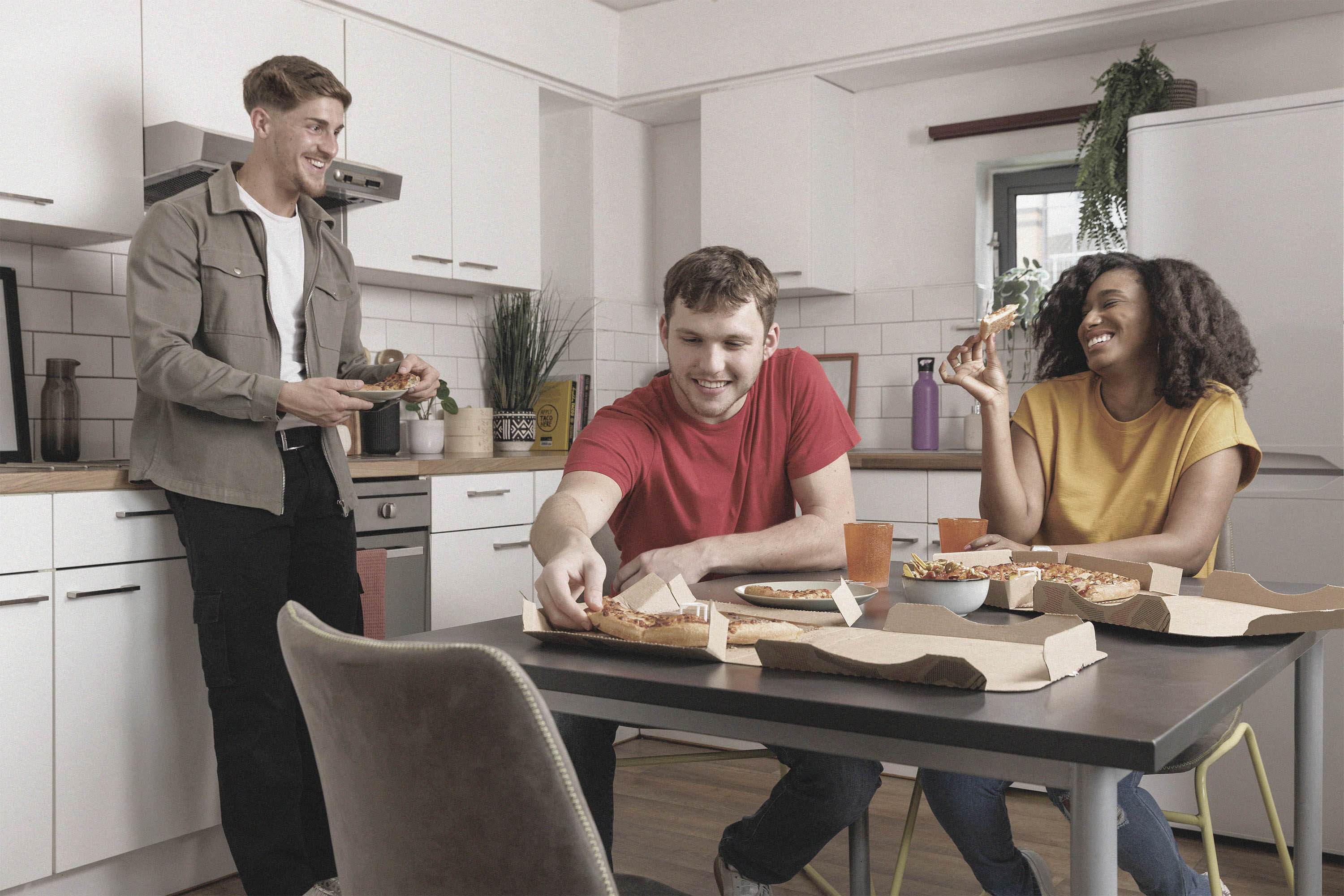 Students eating in shared kitchen at Clarence Dock Village.