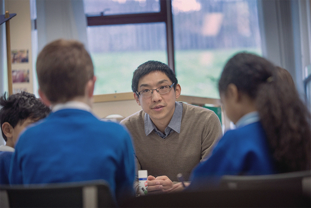 Student teacher working with two children.