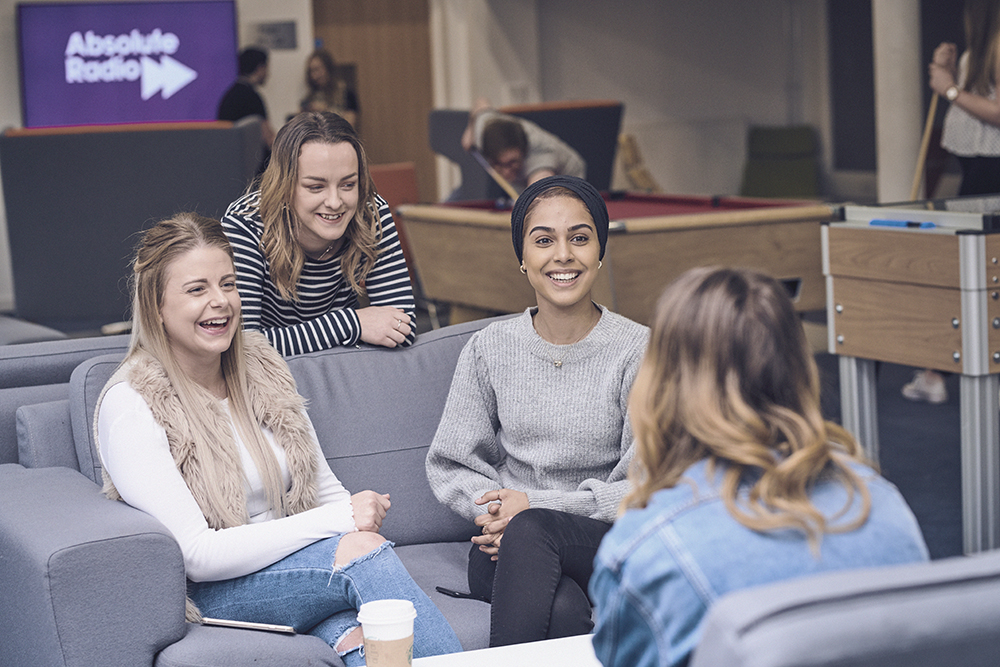 Students talking in Fountains Court common room.