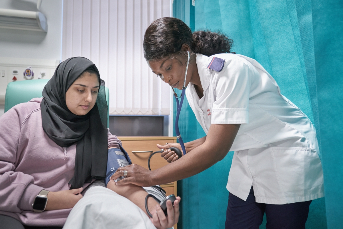 Nursing student giving a blood pressure test.