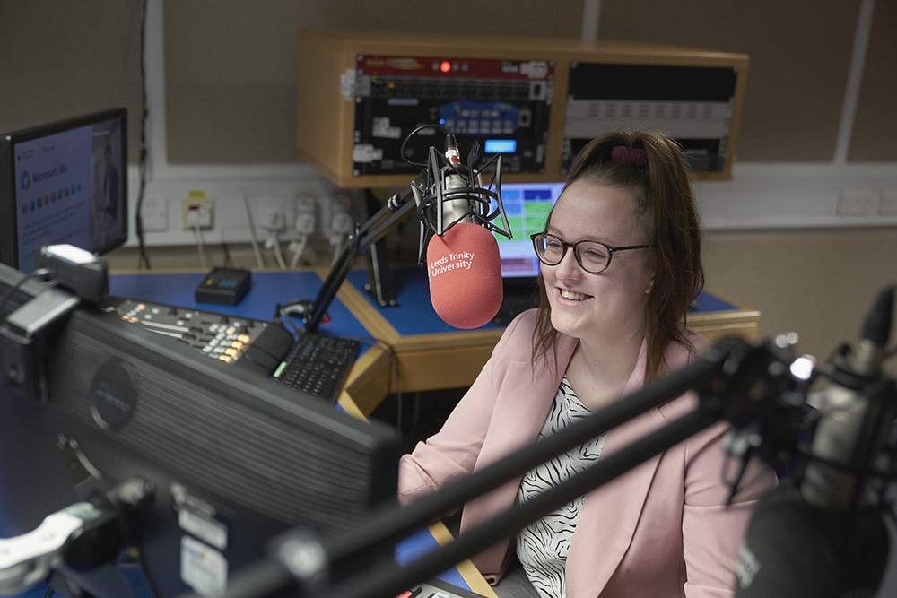 Journalism student records in the radio studio.