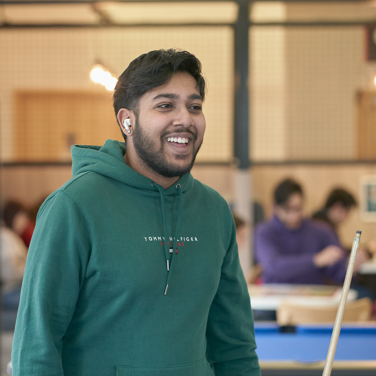 Student playing pool in student union bar..